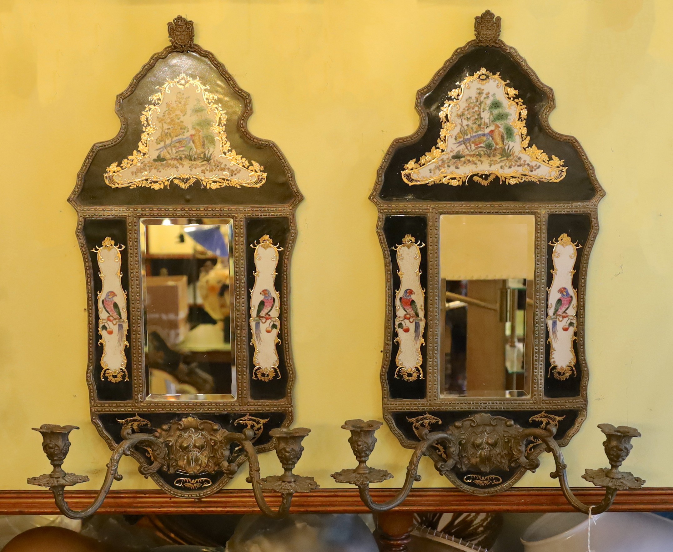 A pair of brass mounted ceramic girandoles in the Louis XIV style, height 64cm. width 38cm